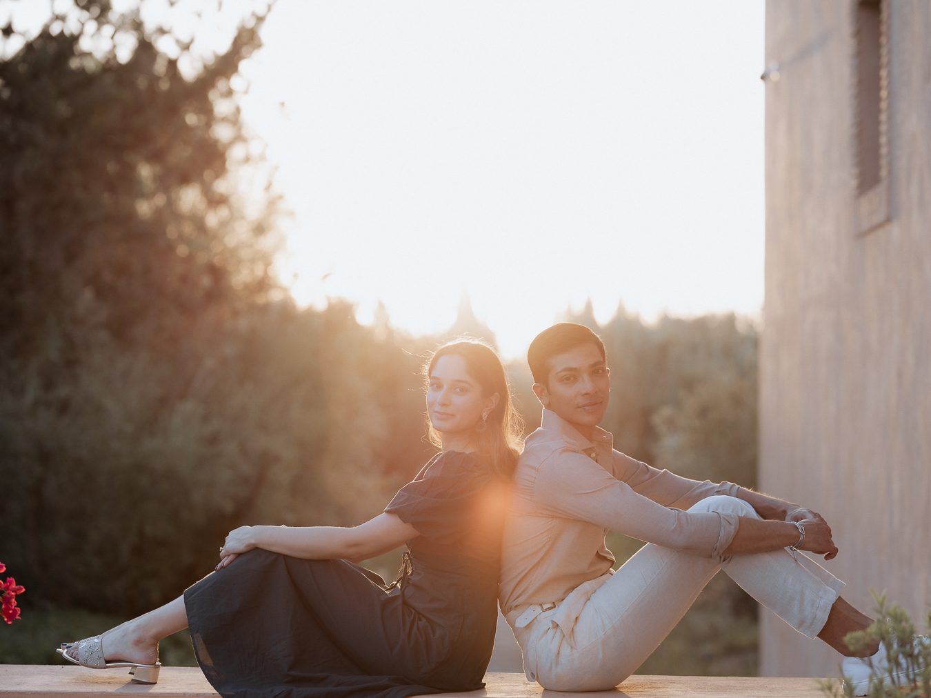 a man and woman sitting back to back, proposal photography in Marrakech