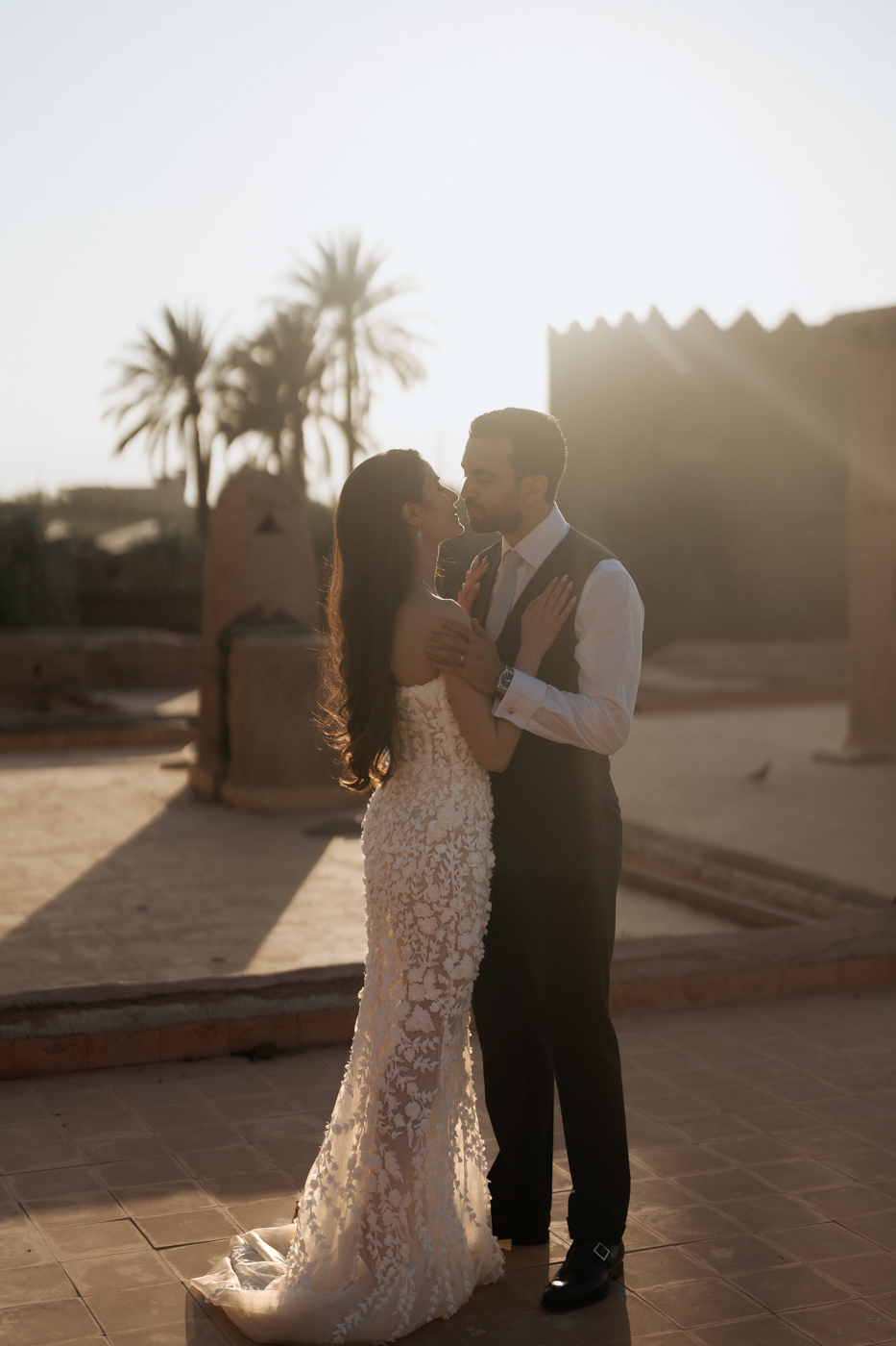 a groom and bride kissing, on roof top beldi country club marrakech